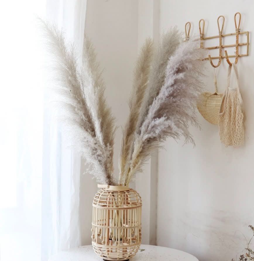 Light beige bamboo hand-woven candle holder with fluffy pampas grass decor, natural home decor.